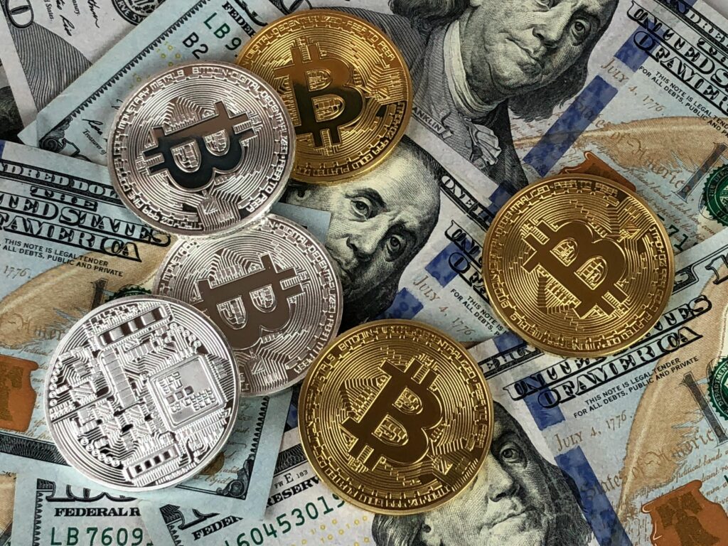 Close-up of bitcoins and US dollar bills symbolizing modern finance and cryptocurrency.